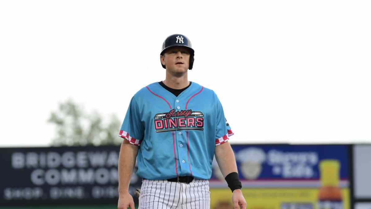 DJ LeMahieu walks on the field wearing a special "Jersey Diners" uniform with pinstriped pants and a Yankees helmet during his rehab assignment with Double-A Somerset.