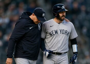 Yankees manager Aaron Boone and catcher Austin Wells together after  an on-road win in April, 2026.