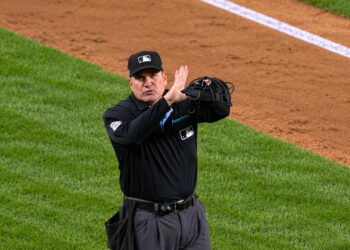 Umpire signals fan interference that overturned an Anthony Volpe HR in the Yankees' 4-3 ALDS loss to the Rays, New York, October 7, 2026.